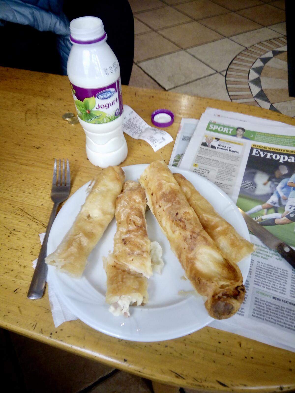 fullsizeoutput_687 assortment of burek: cheese, potato, ham and cheese, cabbage with accompanying yogurt drink. The proper way to eat is to take a bite and follow up with a sip while the food is still in your mouth.